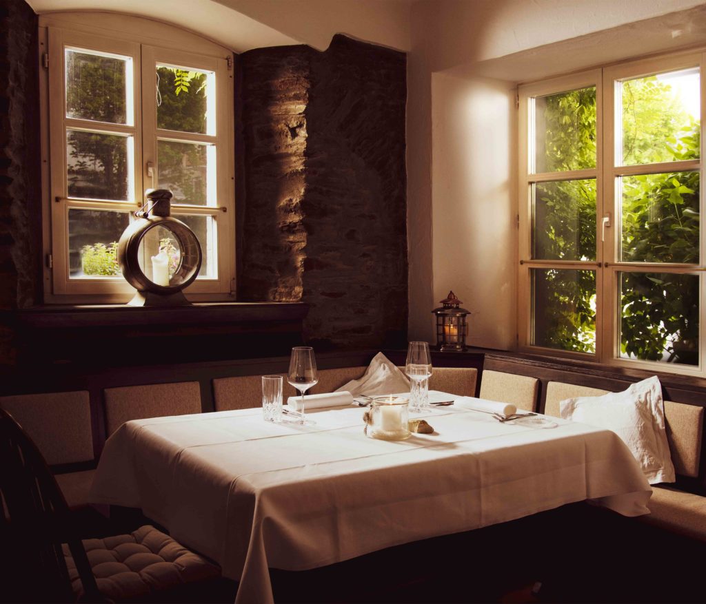 Foto eines gedeckten Tisches im Restaurant Halferschenke, der elegant mit Geschirr, Besteck und Dekoration für die Gäste vorbereitet ist.